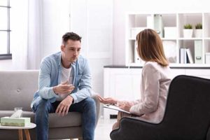man talking with therapist in mental health treatment therapies