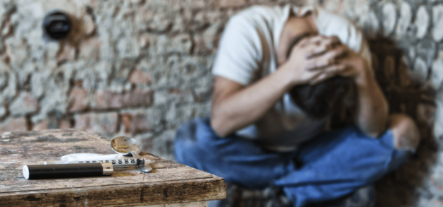 Hard_Choice man in corner with heroin in foreground