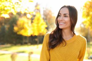 woman smiling outside at outpatient rehab