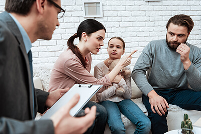 couple with child in family therapy program