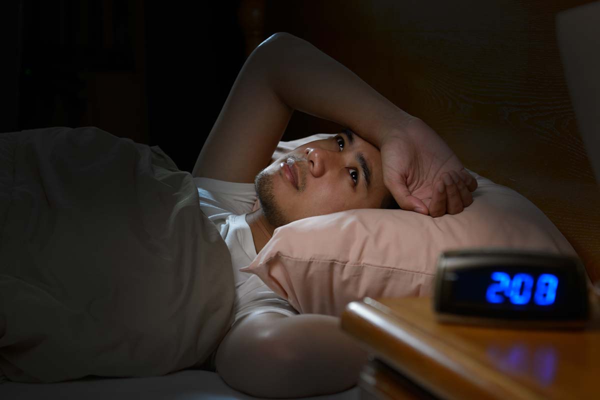 man lying awake struggling with the long term effects of meth