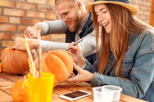 3-Ways-to-Enjoy-a-Sober-Halloween couple enjoying a sober halloween by painting pumpkins