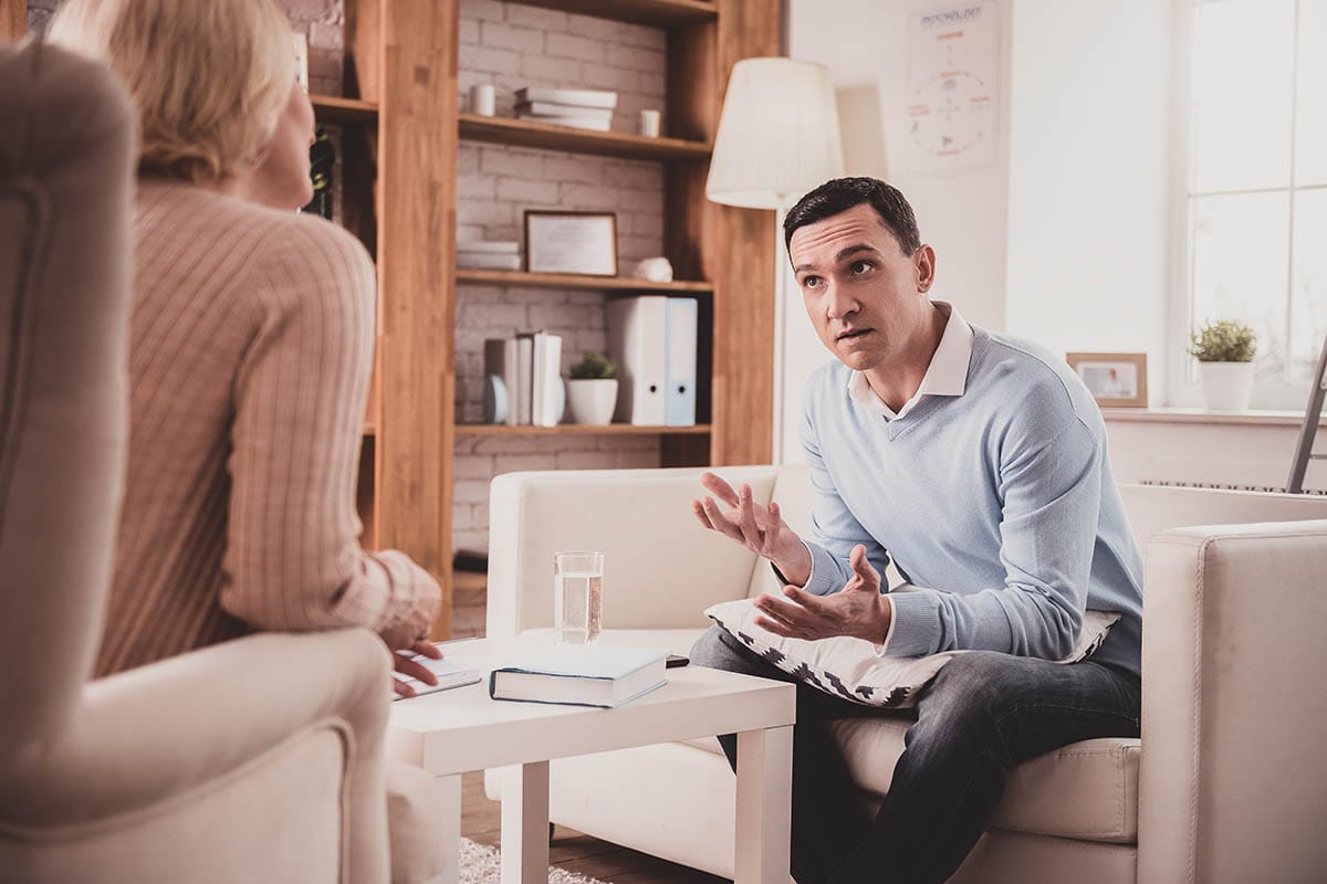 a man talking to his mom about starting an outpatient treatment program