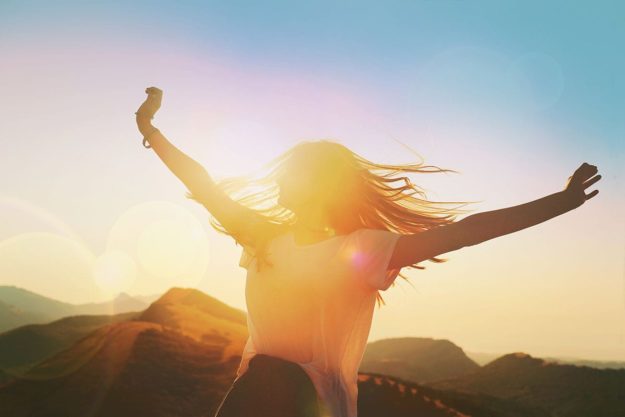 New Years Resolution Get Sober women moving in sunset thinking about new years resolution to get sober