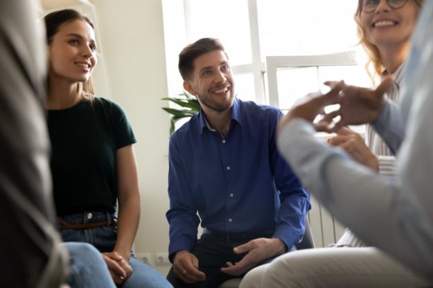 How Can Aftercare Programs Help with Recovery_ people talking in group about how aftercare programs can help with recovery