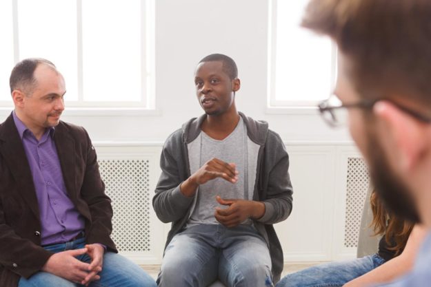 How to Choose a Men’s Addiction Treatment Program men in therapy talking about How to Choose a Men's Addiction Treatment Program