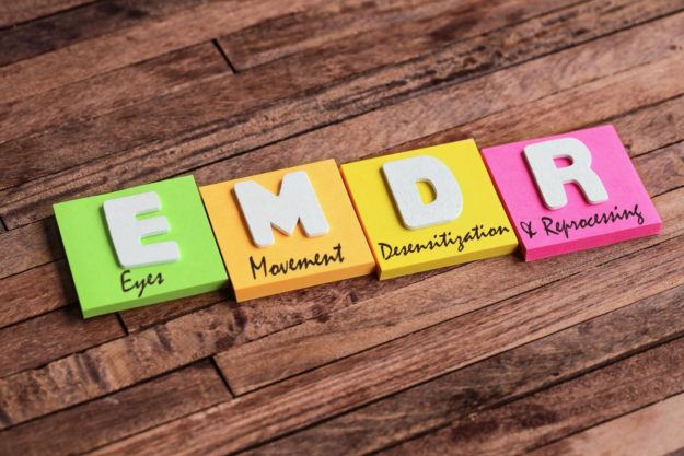 What are the Purposes of EMDR Treatment Centers_ letters that spell "emdr" on pads of paper
