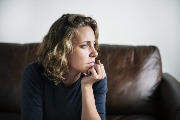 How Meth Impacts Mental Health a woman on a couch thinking about meth and mental health